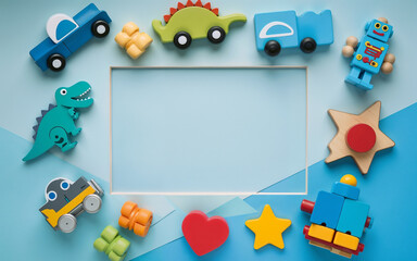 Naklejka premium Colorful plastic and wooden kids toys arranged on a blue background with a blank space for text