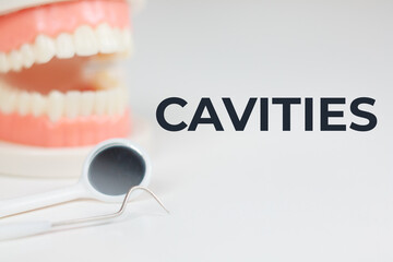 CAVITIES header on dental background