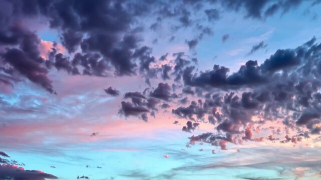 Pastel Pink and Red Sunset Clouds Against a Cyan Blue Sky