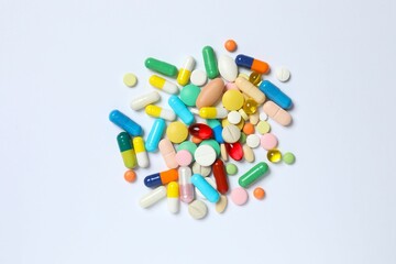 Various pills on white background