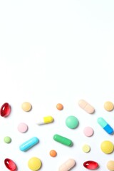 Various pills on white background