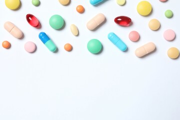 Various pills on white background