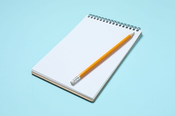 Top view photo of notebook with a pencil on color background with blank space. Business concept