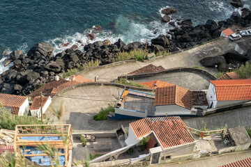 An aerial view of a fishing village by the ocean. Azores