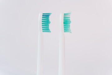 The image of two ultrasonic toothbrush heads, one old and one new, reflects the balance between innovation and the necessity of regular maintenance.