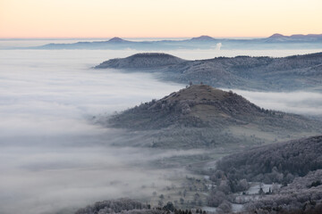 Blick vom Breitenstein, Ochsenwang, Schwäbische Alb auf die drei Kaiserberge - Hohenstaufen, Stuifen und Rechberg. Im Vordergrund die Limburg bei Weilheim Teck im Winter zum Sonnenaufgang mit Nebel.
