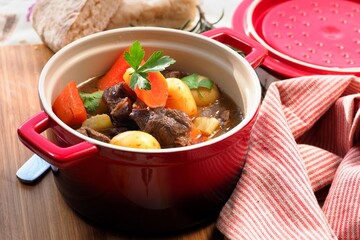 Homemade Beef Stew with Carrots, Potatoes, and Fresh Parsley in a Rustic Dutch Oven