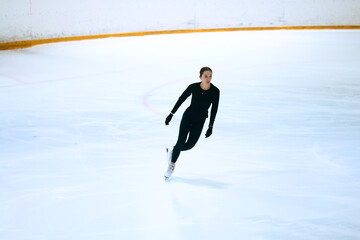 Girl figure skater trains on skates on the ice. © Artur Didyk