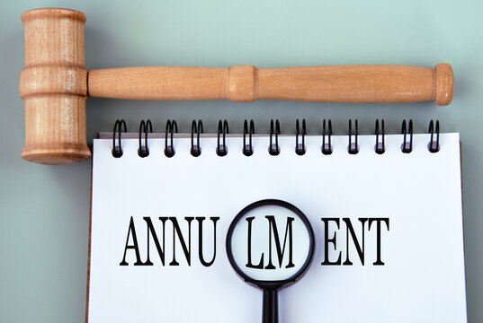 ANNULMENT - word in a notebook on a gray background with a judge's gavel