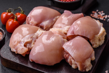 Fresh raw chicken thigh fillets with salt, spices and herbs