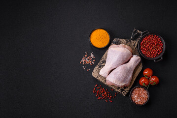 Raw chicken legs with salt, spices and herbs
