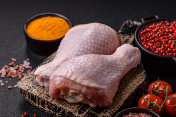 Raw chicken legs with salt, spices and herbs