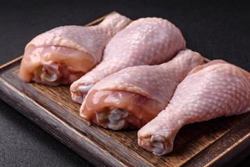 Raw chicken legs with salt, spices and herbs