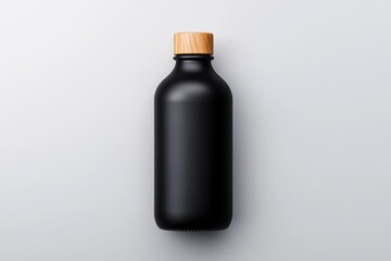 Obraz premium Unique black mockup bottle with a wooden cap set against a minimalistic background