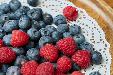 A Beautiful Serving of Fresh Blueberries and Raspberries Delightfully Arranged on a Decorative Plate