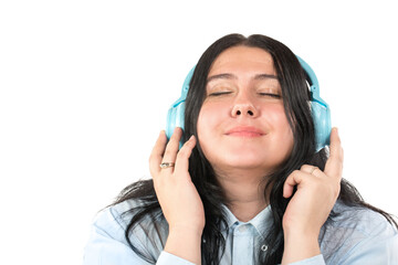 Happy smiling brunette woman with headphones listening to music isolated on white background....