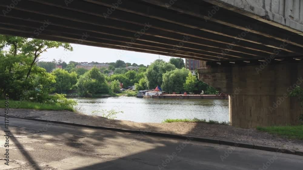 Poster bridge over a river with trees in the background. the bridge is open and the water is calm