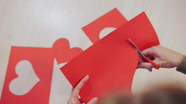 Engaging in the delightful activity of crafting charming Valentine heart shapes using vibrant red paper can spark creativity and joy