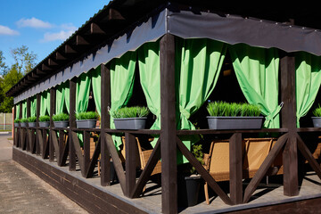Green curtains of a street cafe or terrace.