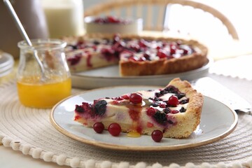 Piece of delicious currant pie with honey on table indoors, closeup