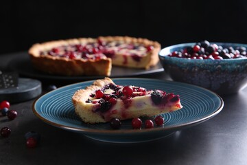 Piece of delicious currant pie and fresh berries on grey table, closeup