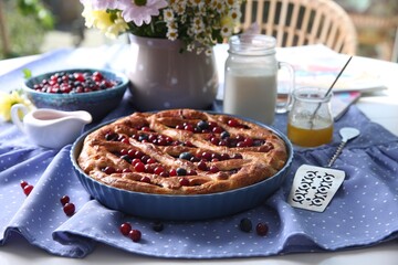 Delicious currant pie with fresh berries served on white table