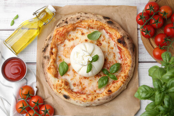 Delicious pizza with burrata cheese served on wooden table, top view