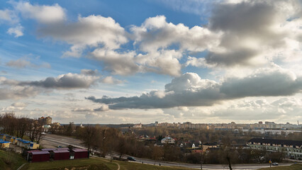 Obraz premium Panoramic view of the city on a sunny summer day. A road bridge crosses the river in the city.