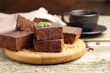 Delicious chocolate puffed rice bars and mint on wooden table, closeup