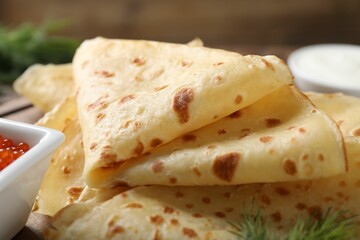 Delicious crepes on brown table, closeup view