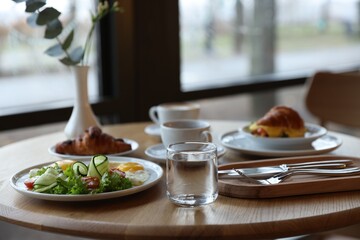 Delicious breakfast served on wooden table in cafe