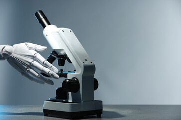 Artificial intelligence. Robot hand working with microscope at table against light grey background, space for text