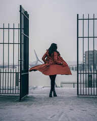 Girl standing in gate on snowy day