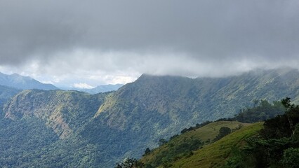 Lush Green Mountains Under Cloud Cover
