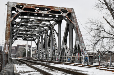 Old iron steel railroad bridge in winter
