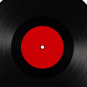 A detailed view of a spinning vinyl record with a bold red label, showcasing visible grooves and motion against a minimalist black background.
