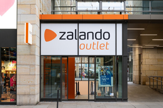 DRESDEN, GERMANY - 3. January 2025: Zalando Outlet Store entrance in the Prager Strasse in the city. Building facade with the logo sign of the fashion and clothing retailer.