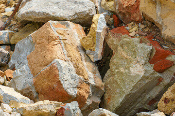 Piles of broken old bricks and other construction debris at the construction site. Construction background.