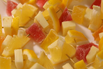 Colorful fruit skewers with vibrant yellow and red pieces for summer snacks