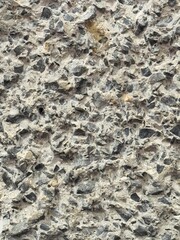 Grey stone chip wall background showing texture with space for copy