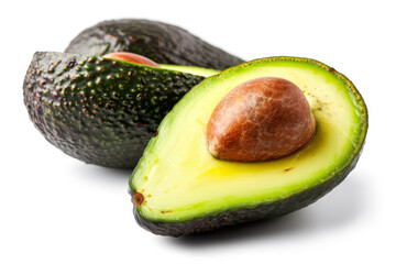 A green avocado with a brown seed in the middle