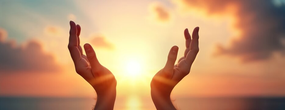 Silhouette hands reaching for sky at sunrise. Spiritual moment of prayer worship against warm sunset backdrop. Peaceful scene suitable for various religious spiritual concepts. Early morning