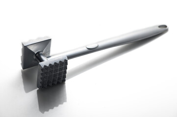 Unique kitchen tool for tenderizing meat with a modern design in a minimalist setting