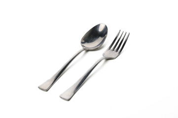 Elegant fork and spoon arranged on a white surface for a minimalist dining experience