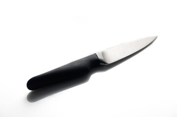 Sharp kitchen knife resting on a clean surface in bright light during morning preparation