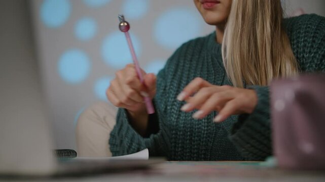Woman Distracted by Phone While Studying