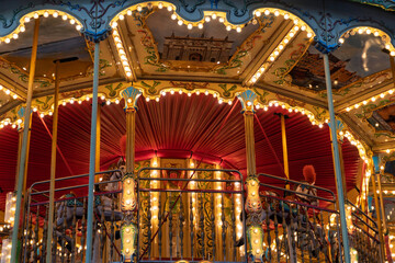 Colorful carousel with ornate decorations and illuminated lights in a festive atmosphere