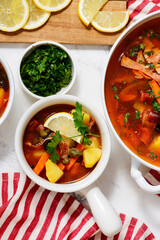 Solyanka. Russian traditional soup with smoked meats and pickles .style rustic