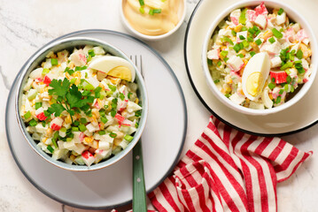 Traditional Russian salad with crab sticks, eggs and corn