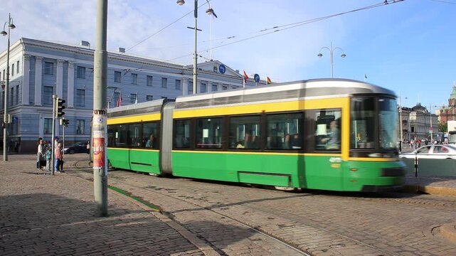 
City trams passing each other as passengers board and disembark at a busy station. A lively urban scene showing public transport in action, capturing the dynamic rhythm of daily life.